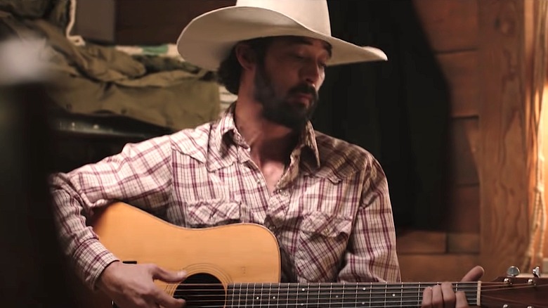 Bingham playing guitar on Yellowstone