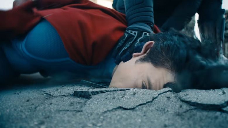Mysterious figure hammering Superman's face into the ground (2025)