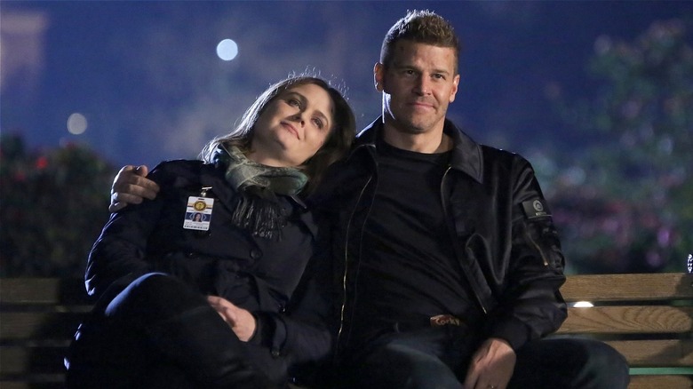 Brennan and Booth sitting on a bench in 