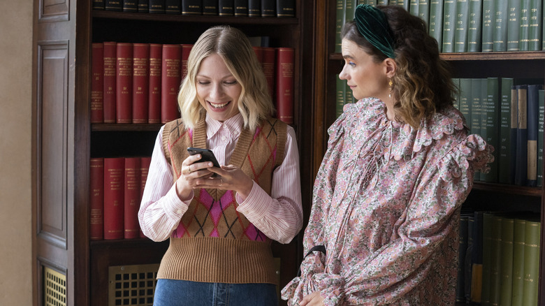 Teachers looking at phone laughing