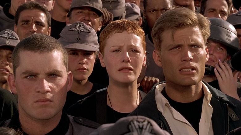 Soldiers standing together looking sad in Starship Troopers