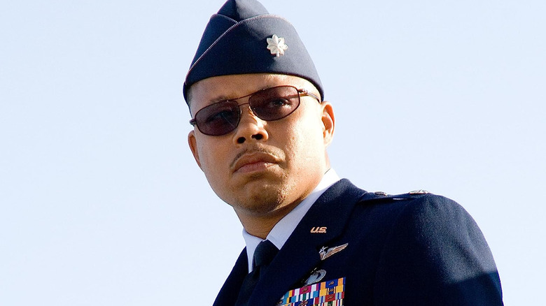 Rhodey in sunglasses looks to his left in "Iron Man" (2008)