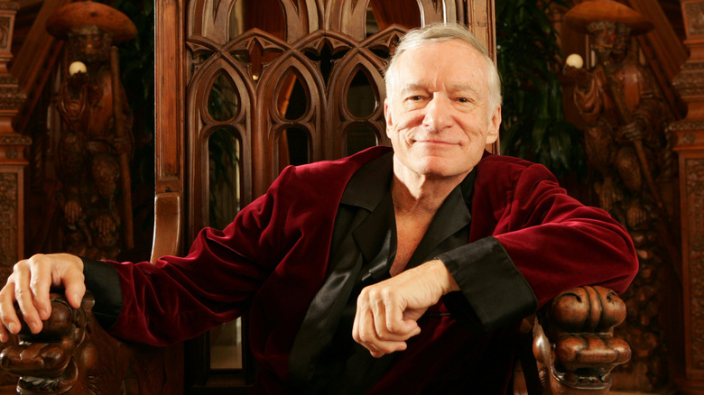 Hugh Hefner posing on fancy chair (2005)