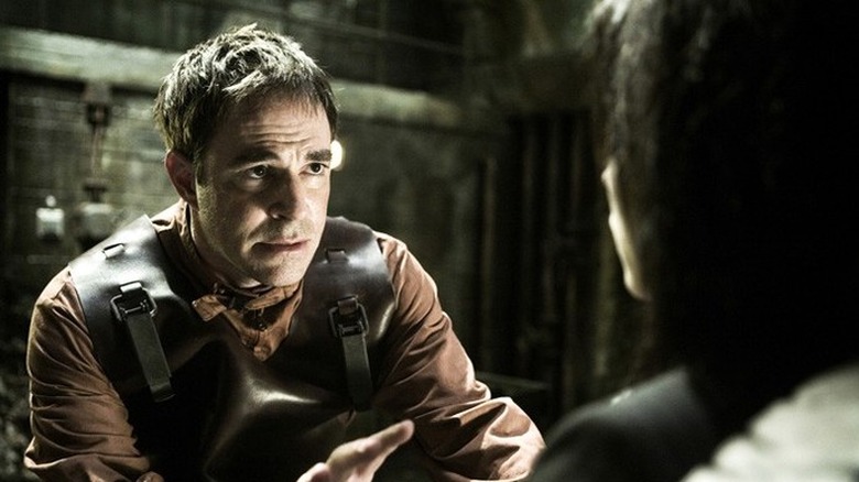 A man checks on his captives