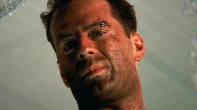 Bruce Willis smirks through broken glass