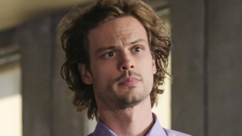 Dr. Spencer Reid standing and listening