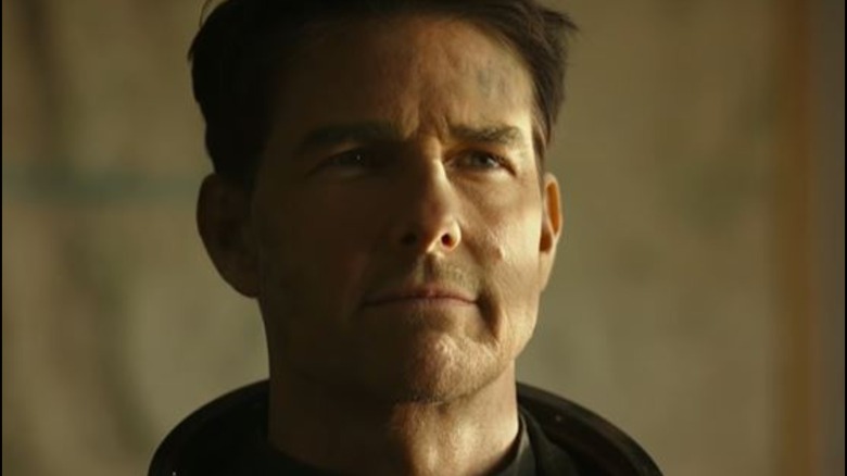Tom Cruise grinning in Top Gun: Maverick