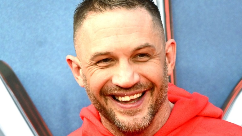 Tom Hardy smiles at event