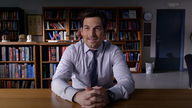 DeLuca sitting at a desk smiling