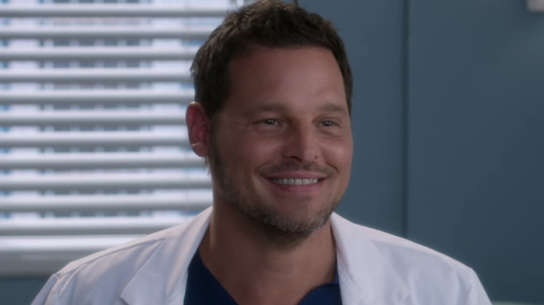 Alex grinning white lab coat