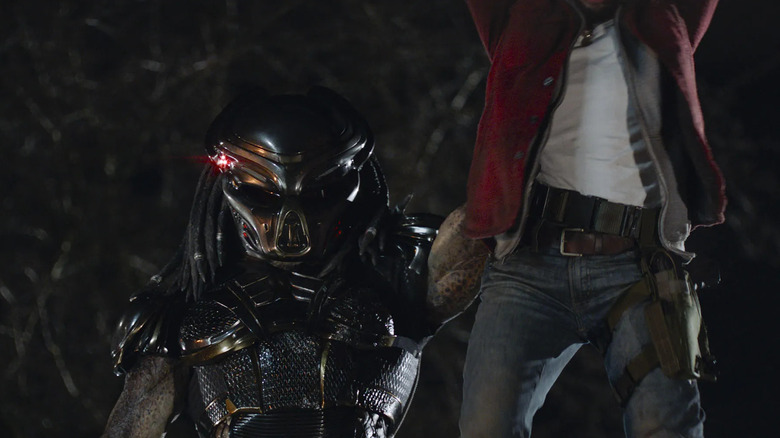 Predator holding a man aloft The Predator