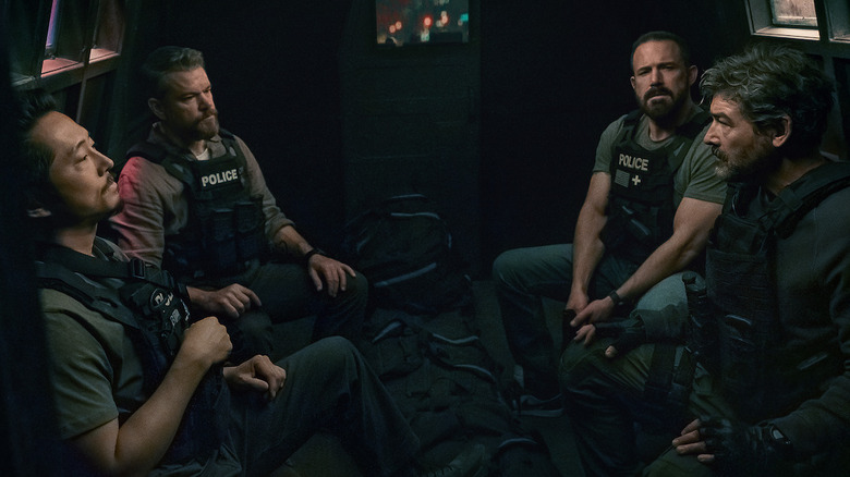 Mike, JD, Dane, and Matty sitting in the back of a van