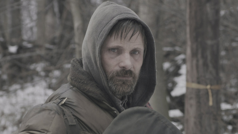 Man stares into the distance in "The Road" (2009)