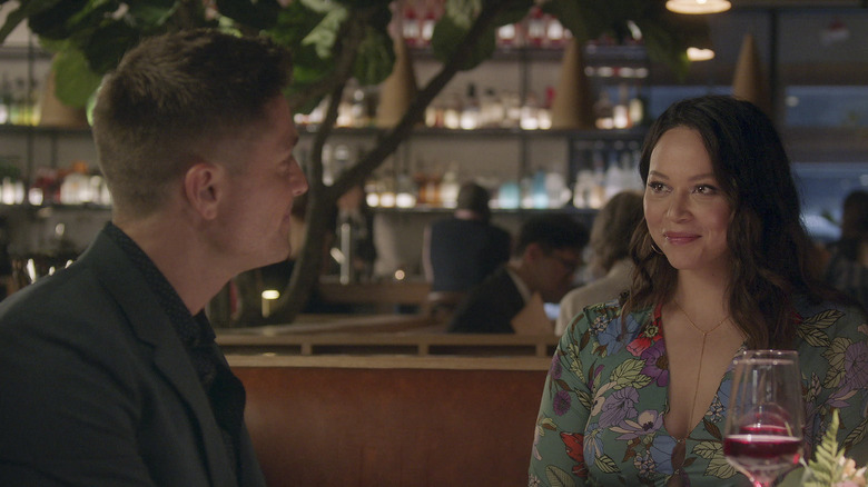 Tim Bradford and Lucy Chen sitting together at a restaurant looking in love