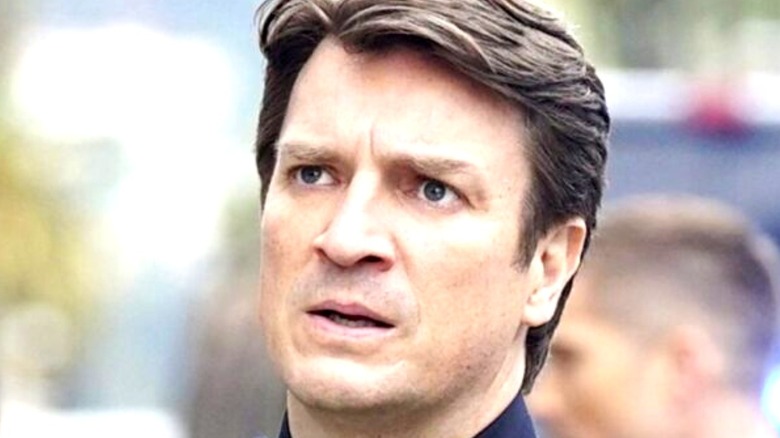 Nathan Fillion looking off to the right