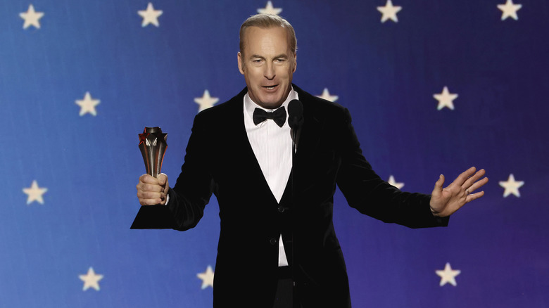 Bob Odenkirk holding award on stage 