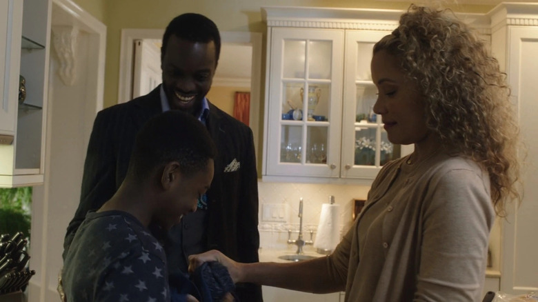Darnell Potter laughs with his wife and son