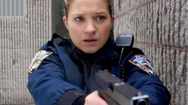 Officer Martin aims her firearm