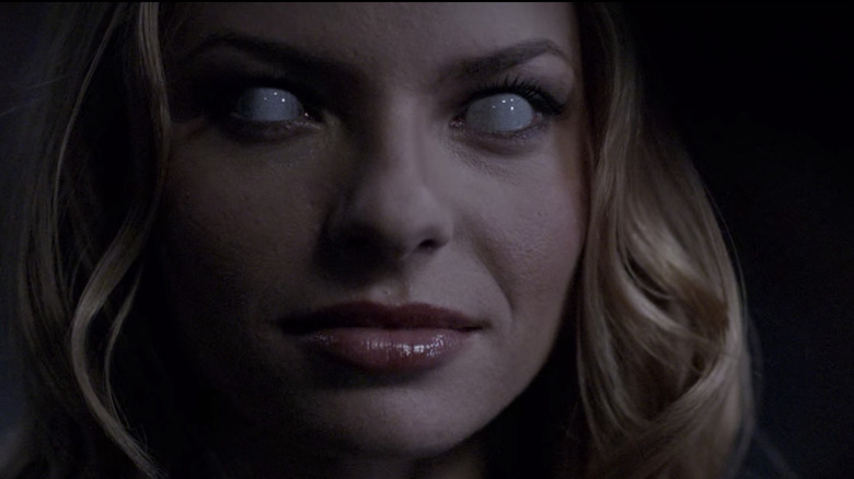 Lilith smiling with white eyes on Supernatural