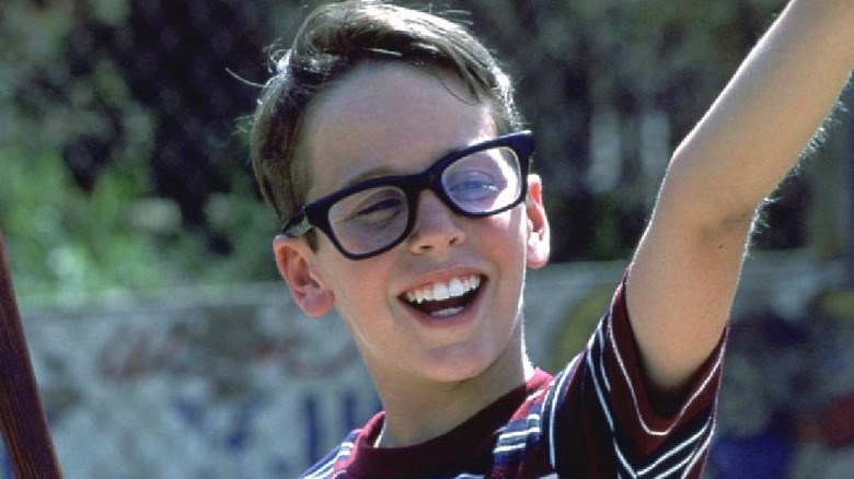 A smiling Squints pointing