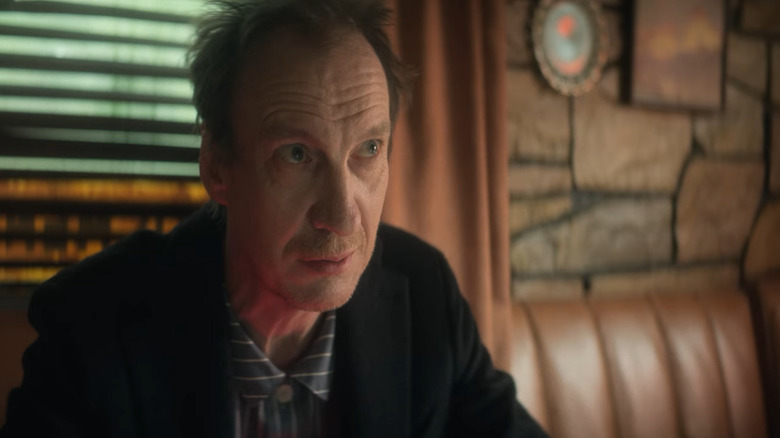 David Thewlis sits in diner booth