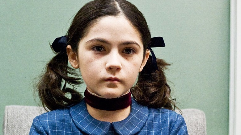 Esther creepily playing piano in Orphan (2009)