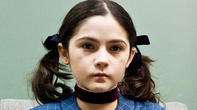 Esther creepily playing piano in Orphan (2009)