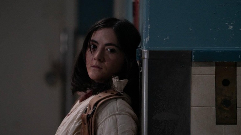 Leena hides behind a corner wall