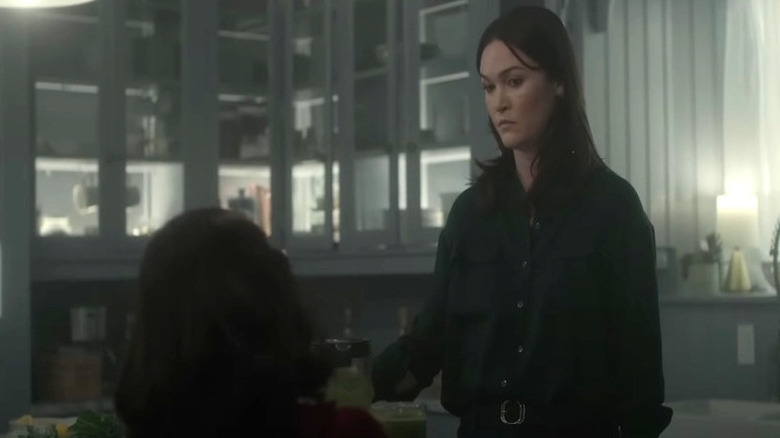 Tricia looks nervously at Leena in the kitchen