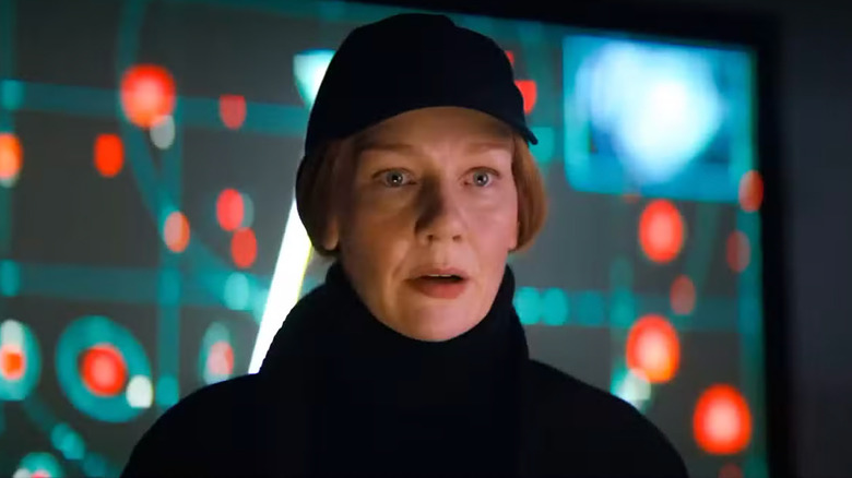 A worried Stratt standing in front of a monitor with flashing red dots in Project Hail Mary