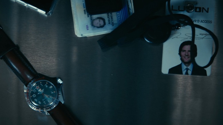 Mark's watch and ID badge in a tray