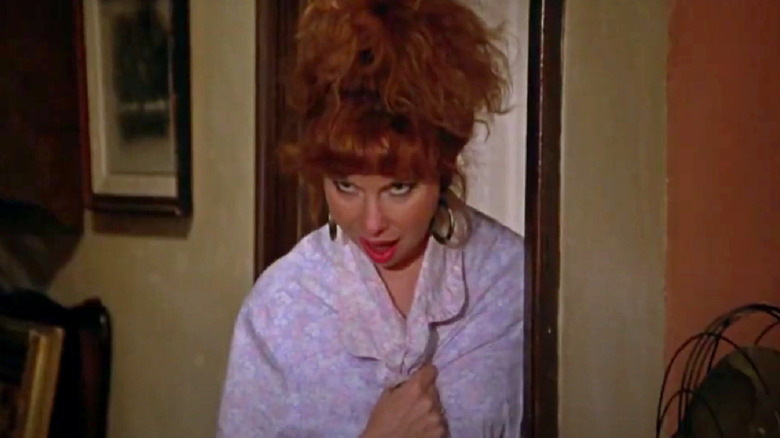 Tina speaks from the bedroom doorway