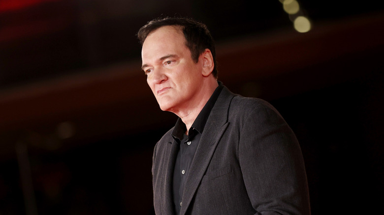 Quentin Tarantino wearing a black suit