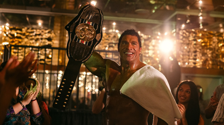 Mark Kerr raises a championship belt in 