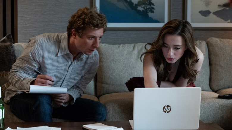 Jeff and Frances working in his hotel room in The Social Reckoning