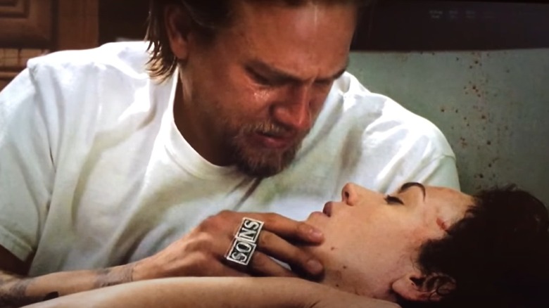 Jax crying holding Tara's face