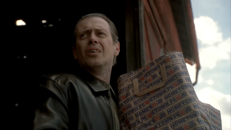 A worried Tony B walks up the porch with groceries