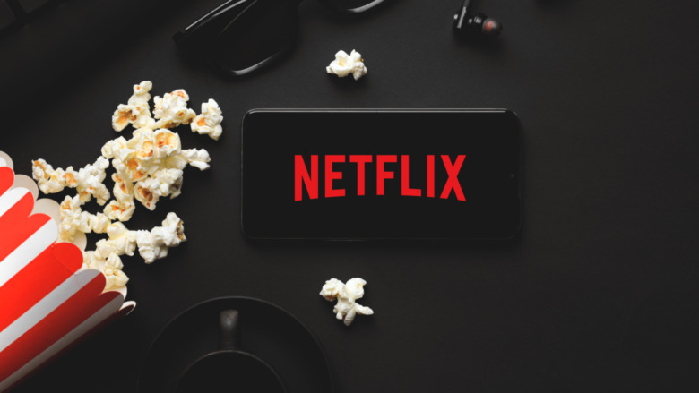 Netflix on phone with popcorn