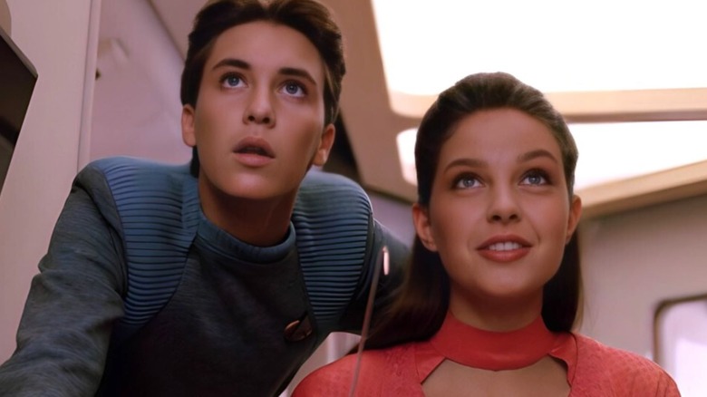 Wesley looking over Robin's shoulder