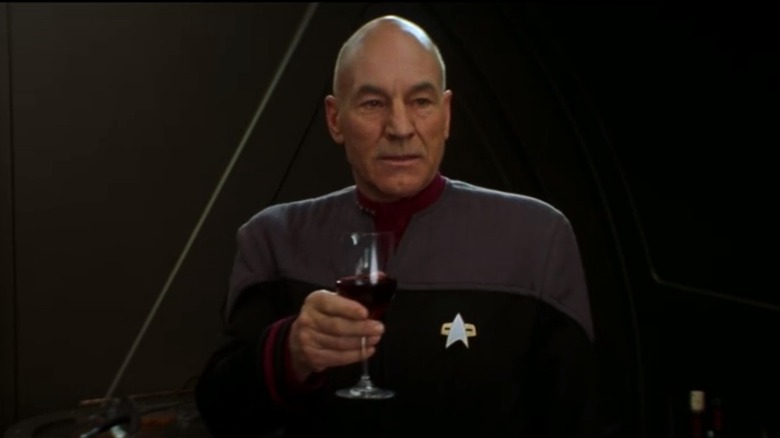 Picard holds a wine glass