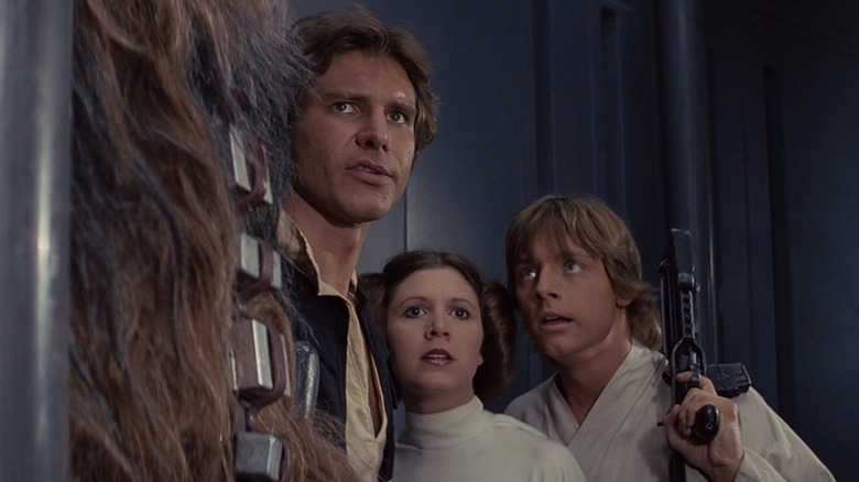 Chewbacca, Han Solo, Leia, and Luke standing
