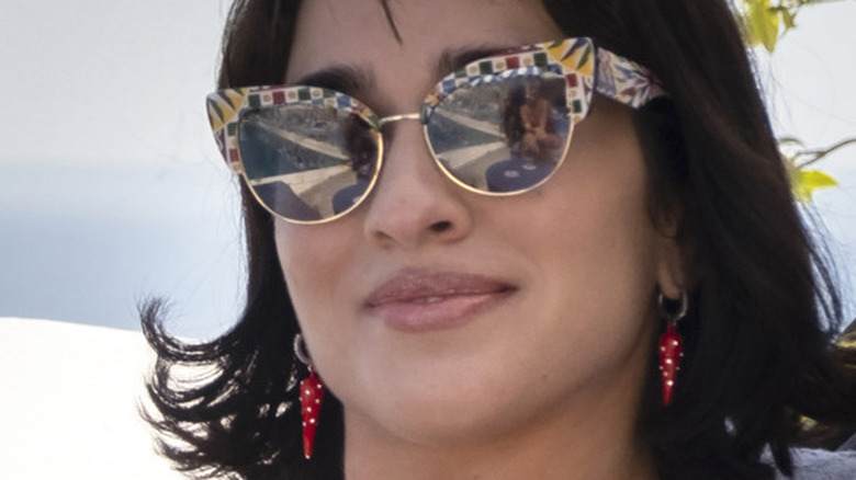 Simona Tabasco holding drink wearing glasses