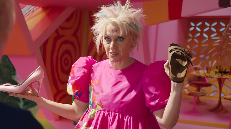 Weird Barbie holding shoes