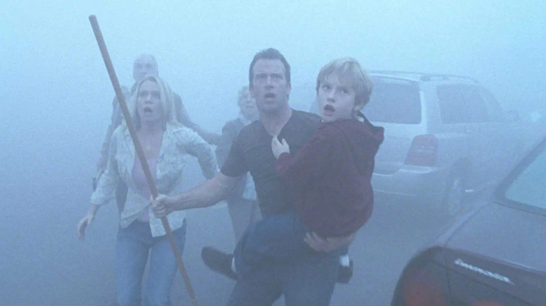 Survivors run through the mist