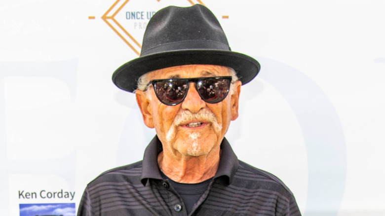 Joe Pesci smiling at a golf tournament