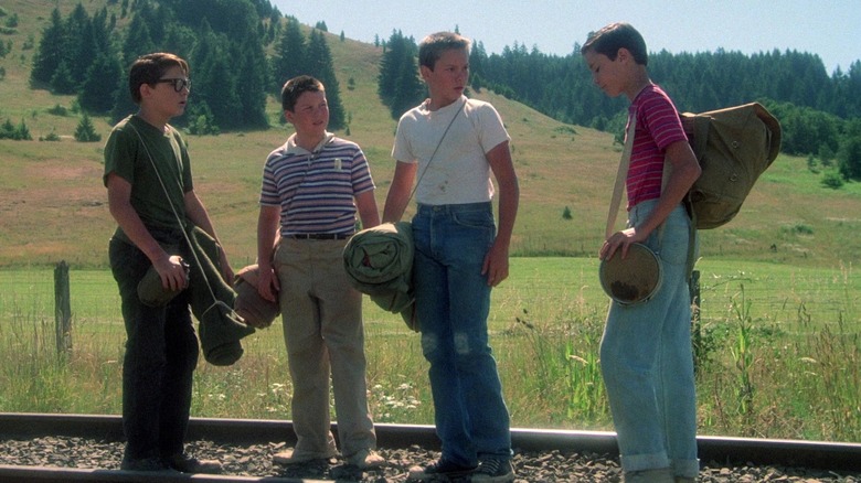 Teddy Duchamp, Vern Tessio, Chris Chambers, and Gordie Lachance stand on train tracks in Stand by Me (1986)