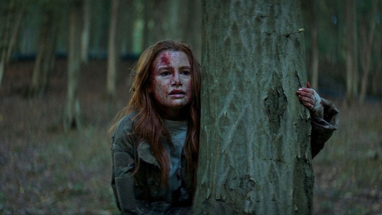 Maya bloodied hiding behind a tree (2025)