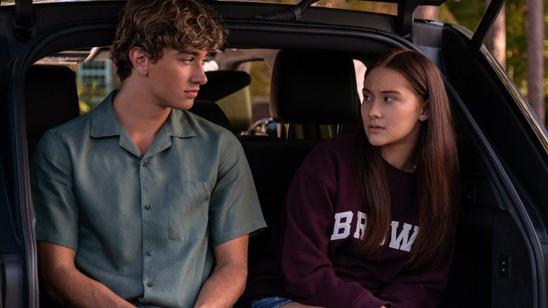 Belly and Jeremiah sitting in the trunk of a car in "The Summer I Turned Pretty"