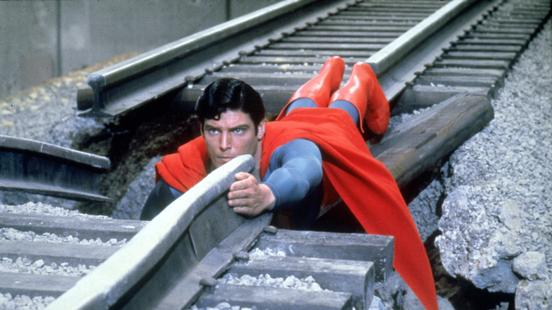 Superman uses his body as a train track