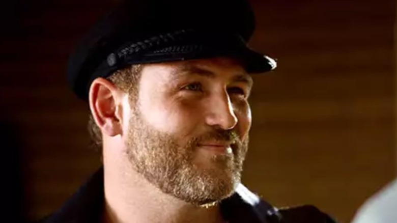 Ty Olssen wearing a black cap